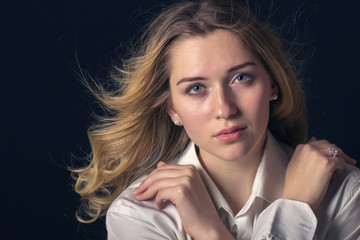 Fototapeta premium Stylish young woman model standing on a dark background