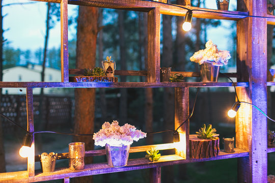 Rustic wedding decor, shelf stand with lilac arrangements and su