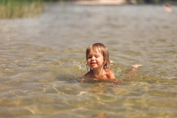 Fototapeta na wymiar Child swim in lake.