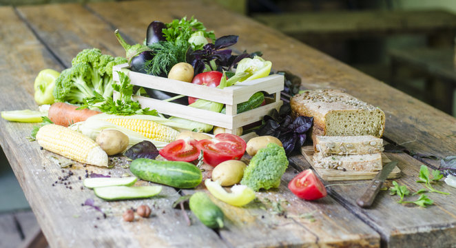 Fototapeta Rye bread with vegetables and spices on a wooden table