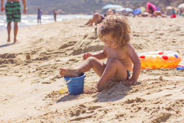 Little Girl Playing On The Beach