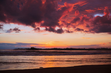 Silhouetted the beach at the sunset time.