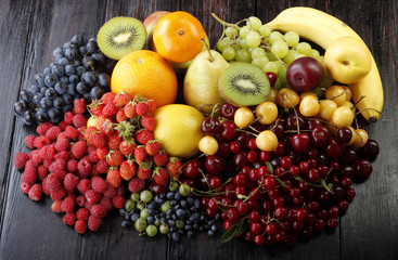 fruits and berries on wooden background