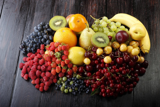 fruits and berries on wooden background