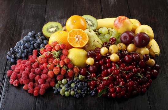 fruits and berries on wooden background