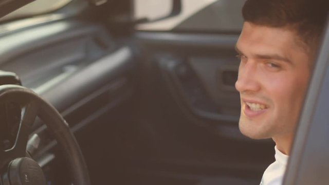 portrait of a young man behing the wheel, slow-motion