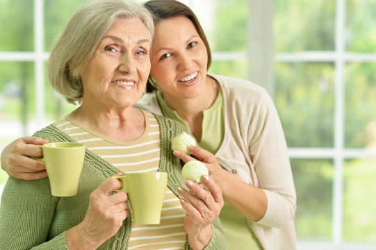 Senior Woman With Daughter  With Tea