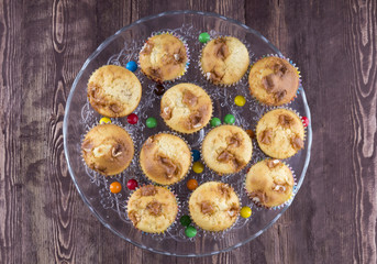muffins on a glass plate on a wooden background top