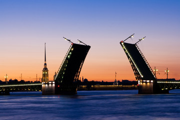 Fototapeta na wymiar Divorced Palace Bridge during the White Nights view on Peter and Paul Cathedral (Petropavlovskaya fortress) , St. Petersburg, Russia. July 3, 2010