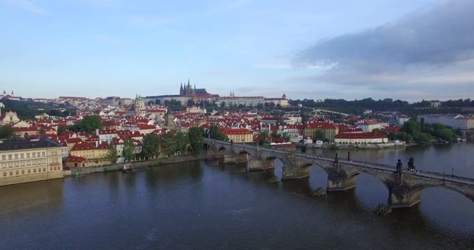 Aerial camera slowly moves towards Prague castle, the Charles Bridge and River Vltava are in shot. Shot at dawn in 4K