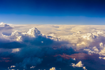 mountain seen through clouds from an airplane