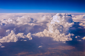 mountain seen through clouds from an airplane