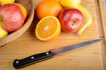 fresh fruits and knife on wooden table. Healthy eating concept