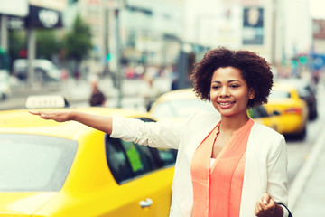 happy african woman catching taxi