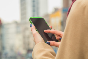Urban girl using cellphone. Shallow depth of field.