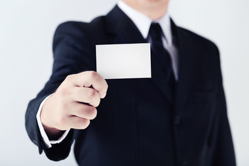 Businessman holding blank card in his hand