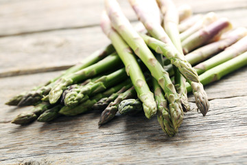 Fresh green asparagus on a grey wooden table