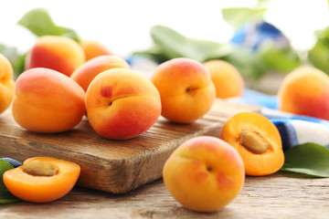 Naklejka na ściany i meble Ripe apricots fruit on grey wooden table