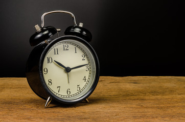 vintage alarm clock on wooden table