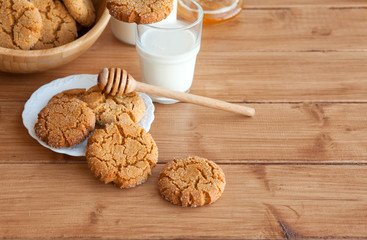 Honey ginger cookies with milk on a rustic background, selective focus