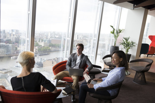 Businesspeople Have Informal Meeting In High Rise Office