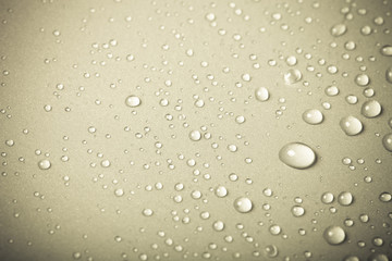 Drops of water on a color background. Beige. Shallow depth of fi