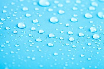 Drops of water on a color background. Blue. Shallow depth of fie