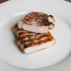 Hot grilled meat on white plate