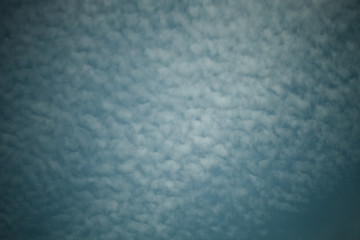 White clouds on a blue sky. Selective focus. Toned