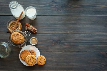 Fototapeta na wymiar Honey ginger cookies with milk on a black background, selective focus