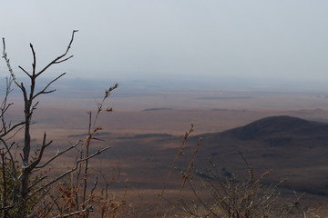Obraz premium View from a hill of a nature reserve into the wide landscape of South Africa