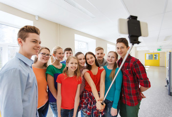group of students taking selfie with smartphone