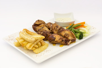 Fried Chicken Wings with fries, salad and chili sauce.  