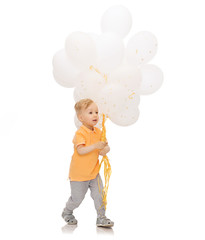 happy little baby boy with bunch of balloons