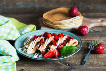 Delicious pancakes with strawberry on wooden background