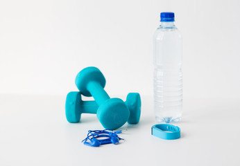 dumbbells, fitness tracker, earphones and bottle