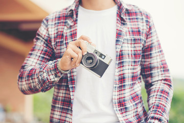 Hipster man searching for an interesting subject for his photo s