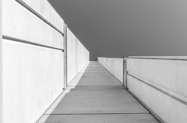 Fototapeta premium Urban Geometry, looking up to building. Modern architecture black and white, concrete and glass. Abstract architectural design. Inspirational, artistic image BW. Artistic image and point of view.