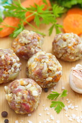 Raw meatballs on a chopping board and ingredients