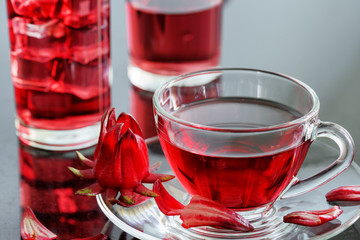 Cup of hibiscus tea (rosella, karkade) on table