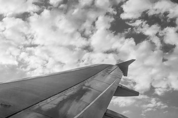 Image of airplane wing in flight. Abstract image of airplane wing isolated. Sky background with point of view from airplane window. Sky and cloud background from airplane view.