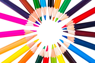 Colored pencils in a circle on a white background closeup
