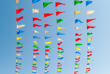 Flag banners blowing in wind. Flapping flags. Streamer flags. Abstract flag colors. Pennant flag strings. Color pennants. Abstract design art. Urban geometry.