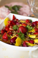 Fruit salad, dessert. Strawberries and mangoes in sweet and sour sesame sauce. 