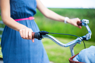 close up of female hands on bicycle handlebar