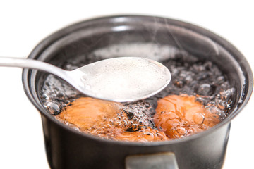 Closeup of three eggs boiling in pot  hot water