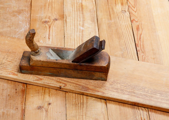 Old wooden plane on the boards