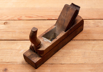 Old plane from a tree on a table from wooden boards