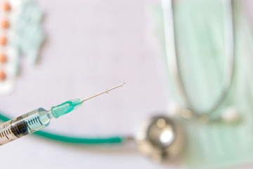 syringe with medical equipment on background 