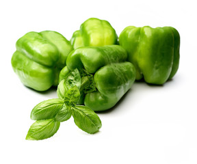Obraz na płótnie Canvas fresh green bell peppers and basil on a white background